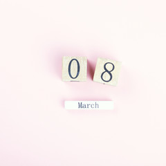 Wooden block calendar International of March 8 on a pink background. Womens Day, is celebrated every year.Holiday concept.Flat lay, top view, copy space
