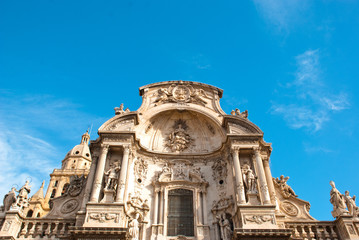 Fototapeta premium Part of facade of catholic cathedral with columns and sky in Spain.Architecture of baroque and renaissance style.