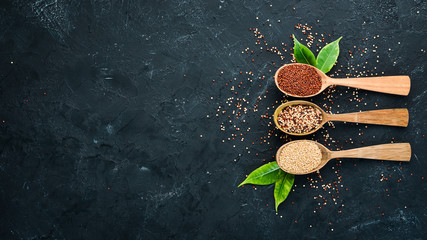 Set of quinoa Red, white and brown quinoa. On a black background. Top view. Free copy space.