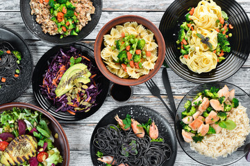 Food Background. Pasta, rice, risotto, salad. On a white wooden background. Free copy space.