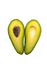 Two halves of avocado on the table. Isolated background