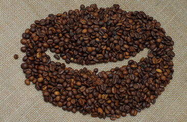 Coffee beans. Coffee beans on burlap in the form of coffee bean