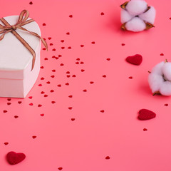 St. Valentine day background. Gift box with gold ribbon and lights on a pink background. Holiday background