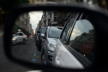 reflection in the mirror of a rear-view mirror of a car showing Florida street at the dawn of a winter day in the city of Vitoria-Gasteiz (alava). Basque Country, Spain