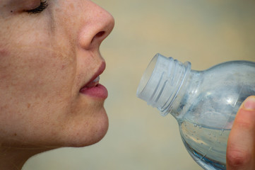 Women drinking from a water bottle Close up camera.