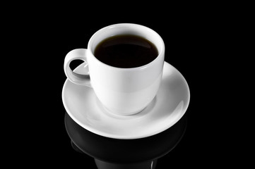 Cup of coffee on black reflective background.