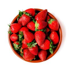 Heap of fresh strawberries in ceramic bowl isolated on  white background. Top view