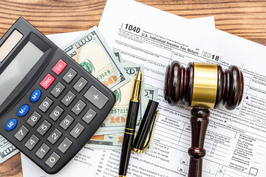 Gavel With Calculator And Money  On Tax Form. Top View. Tax Law.