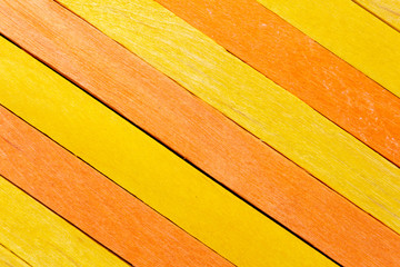 Yellow diagonal colored wooden background with orange stripe