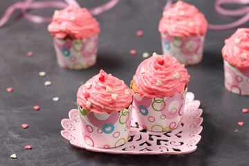 Homemade cupcakes with cream on a dark background. Concept for Valentine's Day, Birthday, March 8 and Mother's Day
