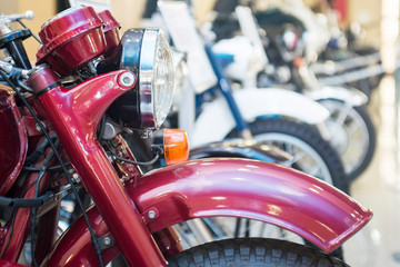 Fototapeta premium Motorbike, motorcycle parked in row in city street. Close up of wheel. Row of many motorcycle at the showroom for sale