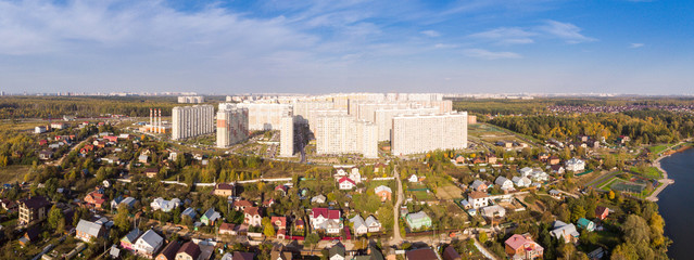 New district with high-rise buildings in the new Moscow on the background of low-rise private...