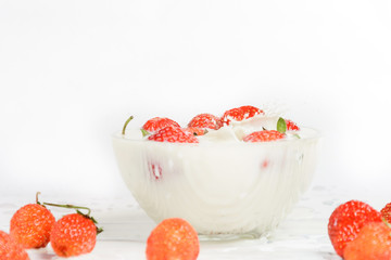 Fresh milk with homemade sweet strawberries on a white background.