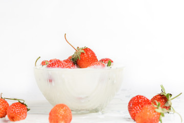 Fresh milk with homemade sweet strawberries on a white background.