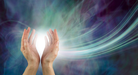 Stunning Healing Energy phenomenon  - pair of hands reaching up into a ball of white  energy with a laser trail and green blue purple ethereal energy field  background