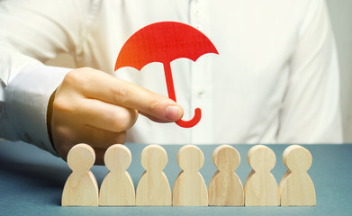 Boss holding a red umbrella and defending his team with a gesture of protection. Life insurance....