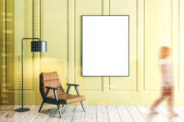 Yellow living room, armchair and poster, woman