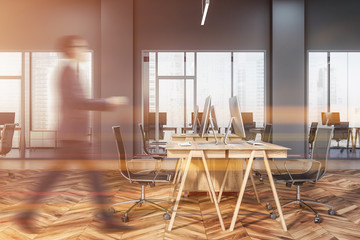 Businessman in gray open space office