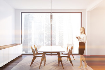 White stylish dining room interior, woman