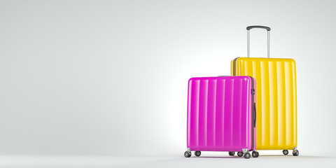 Pink and yellow suitcases on white