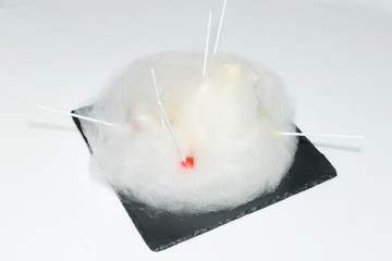 Beautiful dessert serving. White cotton candy. Dessert from sugar. Cotton candy which lies on a...