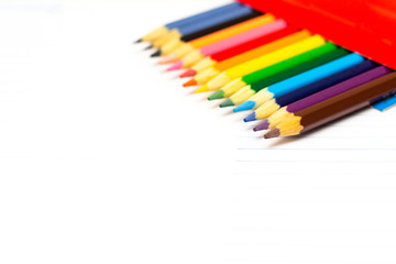 Colored pencils with light background. Back to school. School supplies. Space for text