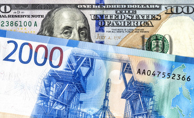 American 100 dollar banknote and 2000 russian roubles