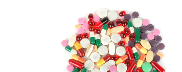 Сolorful pills on white background. Free space for text. Wide photo .