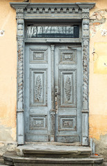 Fototapeta na wymiar Front view of vintage doors with made of authentic material in a very old building . ancient doors in the monuments of architecture city Drohobych, Ukraine