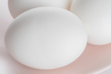 Fototapeta na wymiar Three easter eggs on trendy pink pastel plate