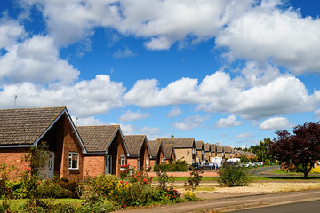 Naklejka premium Street with bungalow houses. Summer time