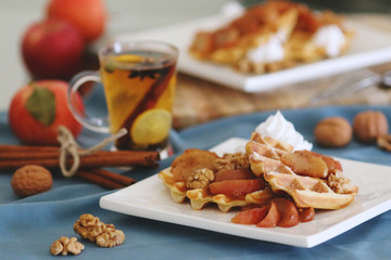 Obraz na płótnie Canvas waffles sered with walnuts, honey and baked aples