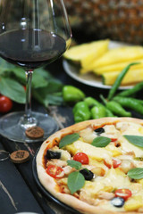 Pineapple pizza served with wine