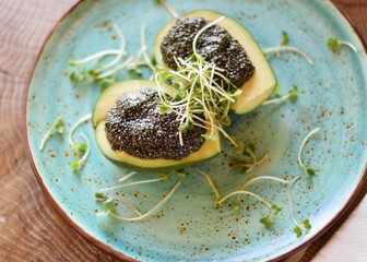Avocado with Chia seeds on a large flat plate. The concept of healthy eating, vegetarianism, veganism and diet food