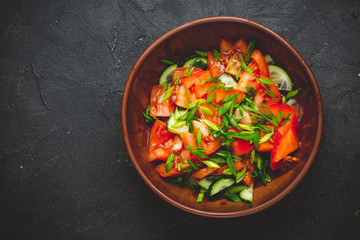 Fototapeta na wymiar Healthy vegetable salad of fresh tomato, cucumber, onion, spinach, lettuce