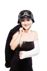 girl with a broken arm in plaster, wearing motorcycle helmet