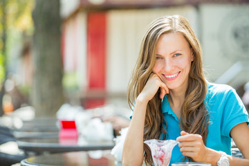 Beautiful girl resting in a summer cafe