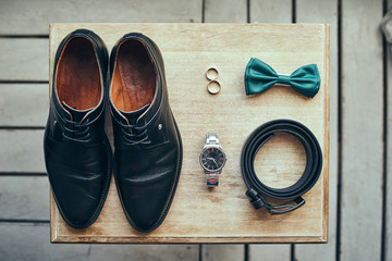 different accessories of a businessman for creating a style of a people lie on a wooden background