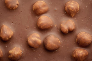 Background of milk chocolate with a lot of nuts