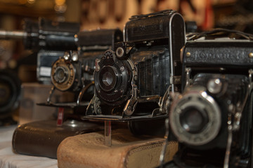 Ancient Folding Cameras with Bellows on their Leather Cases