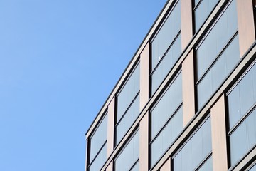 Obraz premium Modern apartment buildings on a sunny day with a blue sky. Facade of a modern apartment building