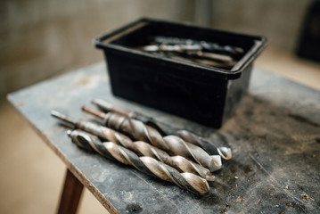 set of steel milling cutters for milling cutters in a rectangular box on the old black table,...
