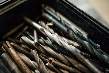 set of steel milling cutters for milling cutters in a rectangular box on the old black table,...