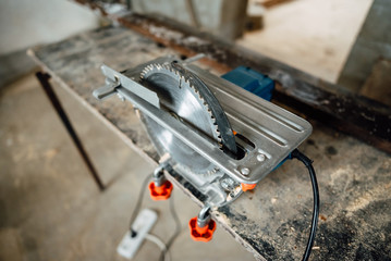 circular saw for working with wood with metal fixed on the table, a working tool for working in construction