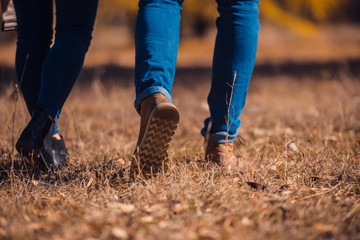 A boy and a girl in jeans in the park