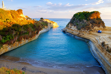 Famous Canal d'Amour beach with beautiful rocky coastline in amazing blue Ionian Sea at sunrise in...