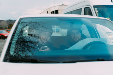 Two Thieves parked in an ally waiting while talking on the phone, observing their target and...