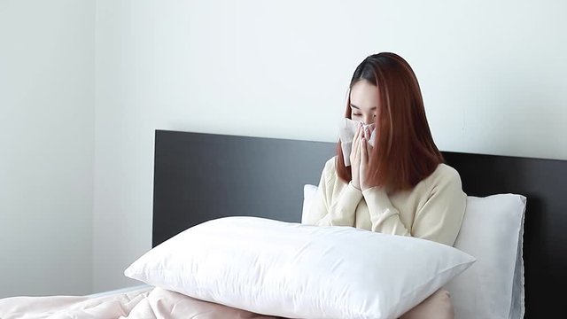 Sick And Ill Beautiful Woman. She’s Lying On The Bed And Sneezing Her Nose. The Framing Of The Clip Is Fixed.