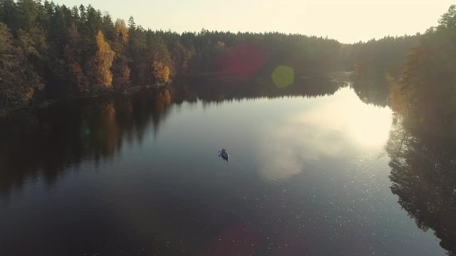 Aerial view of canoeing on lake at sunset