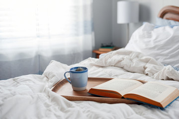 Fototapeta na wymiar Tea and book in bed